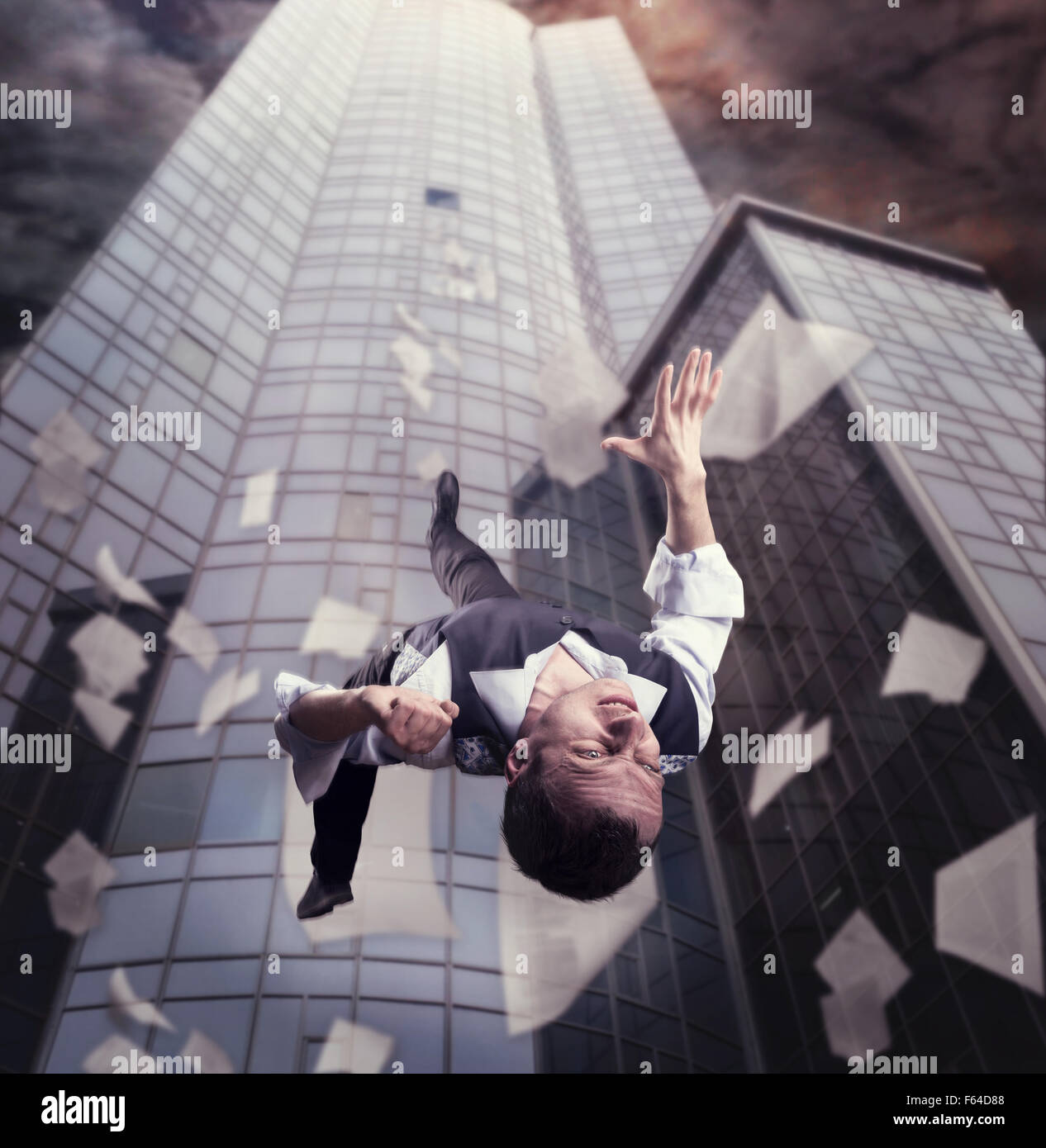 Businessman is falling down from the tall office building Stock Photo