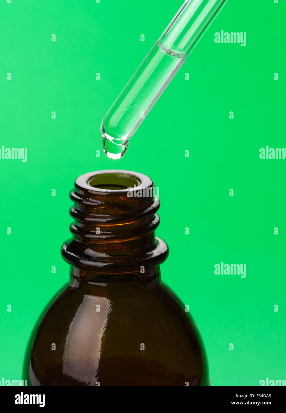 Pouring medical drops into a brown glass bottle Stock Photo