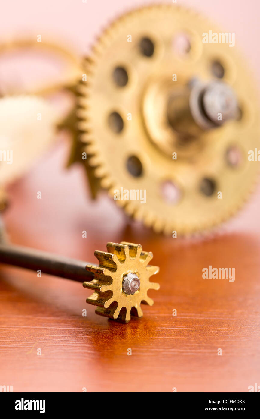 Various clock gears on the wooden table macro Stock Photo Alamy