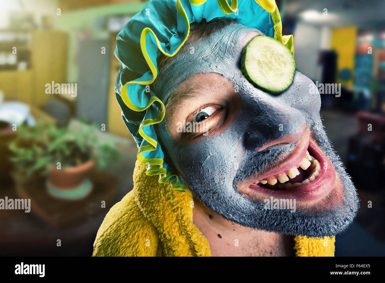 Insane man with face pack in home cosy interior Stock Photo