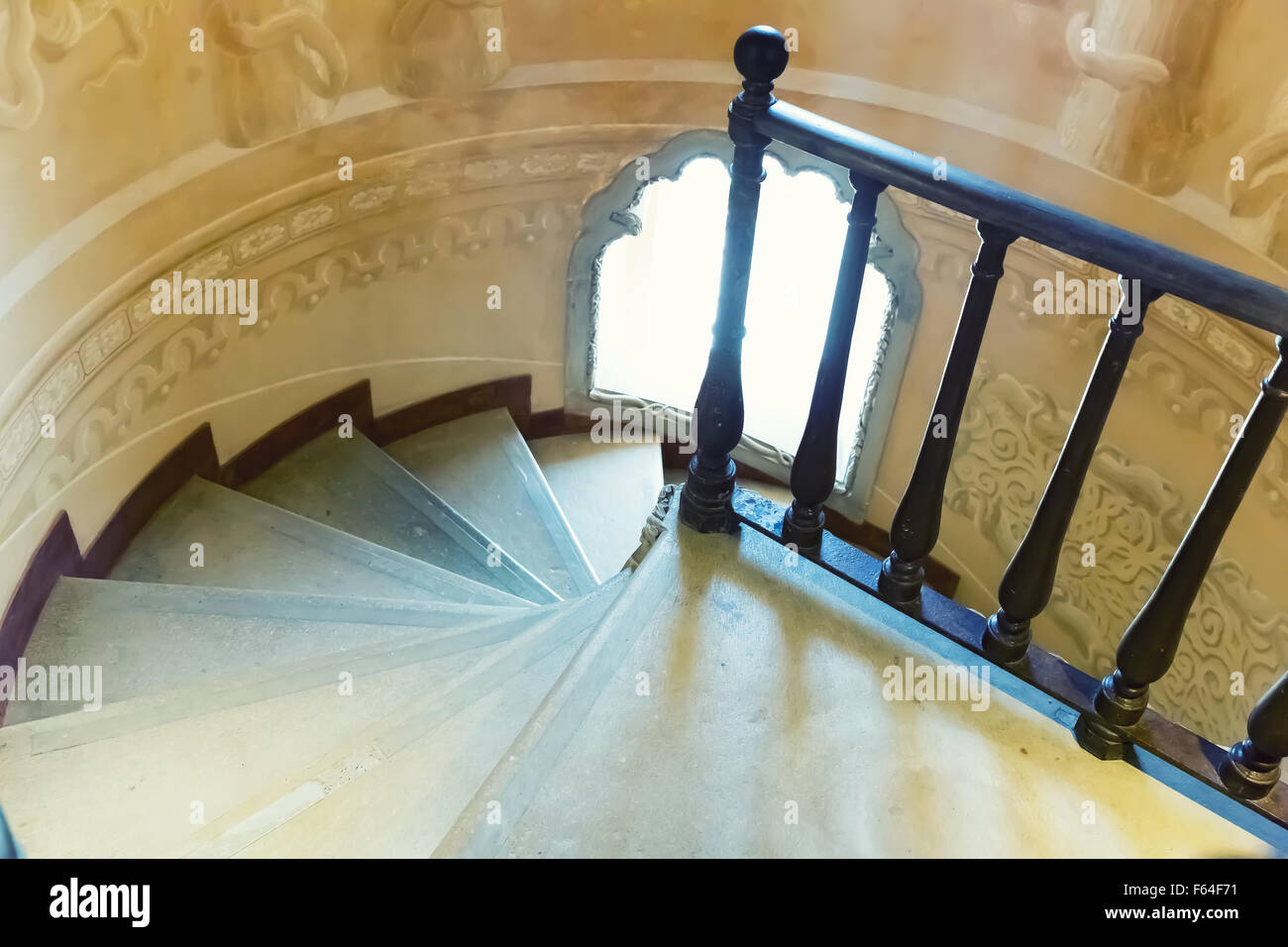 Spiral stairs with a little round window Stock Photo
