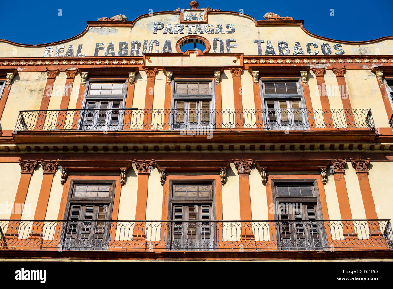 The old, striped Partagas Cigar factory with balconies in Havana, Cuba Stock Photo