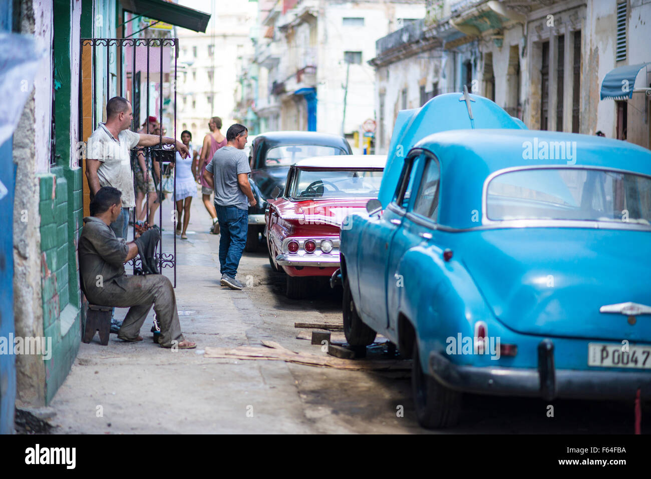 Mechanics working on a a vintage American car in Havana, Cuba Stock Photo