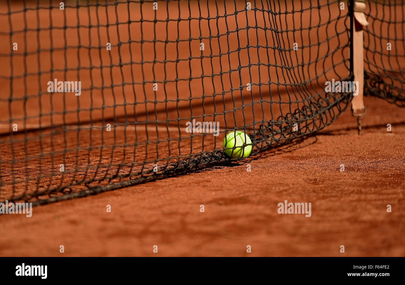 Detail shot with a tennis ball close to the net on a tennis clay court Stock Photo