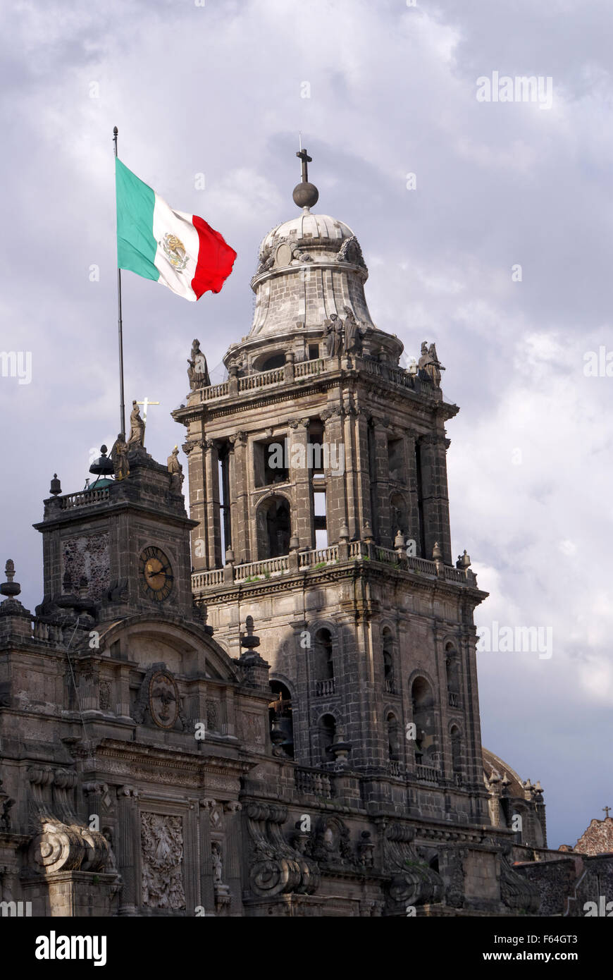 Mexican flag flying over the Metropolitan cathedral in downtown Mexico City Stock Photo