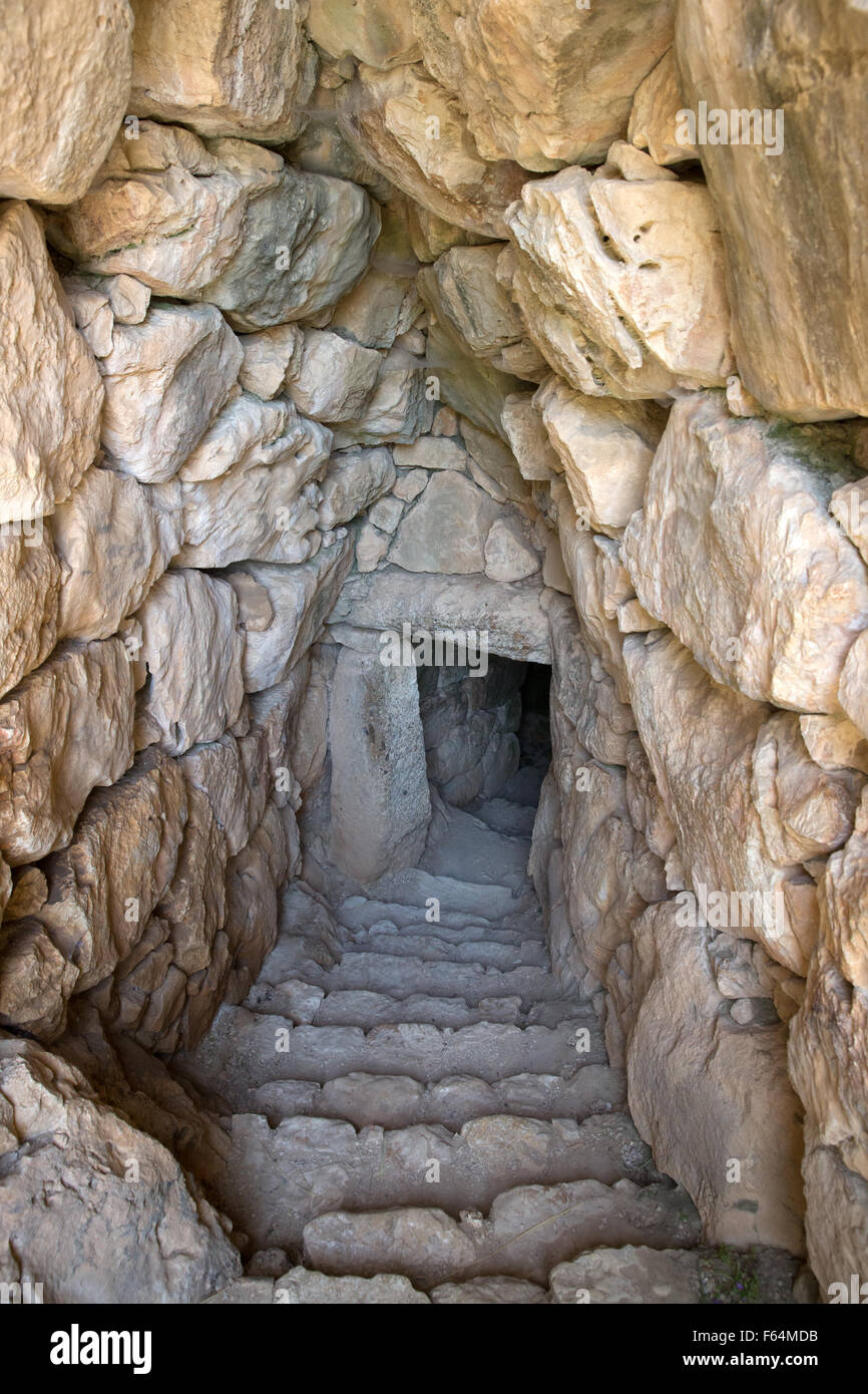 Corbeled stone arch and stairway leading down to an underground cistern at the historic site of Mycenae, Greece Stock Photo
