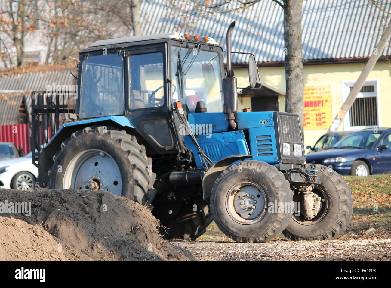 blue power tractor work on street Stock Photo