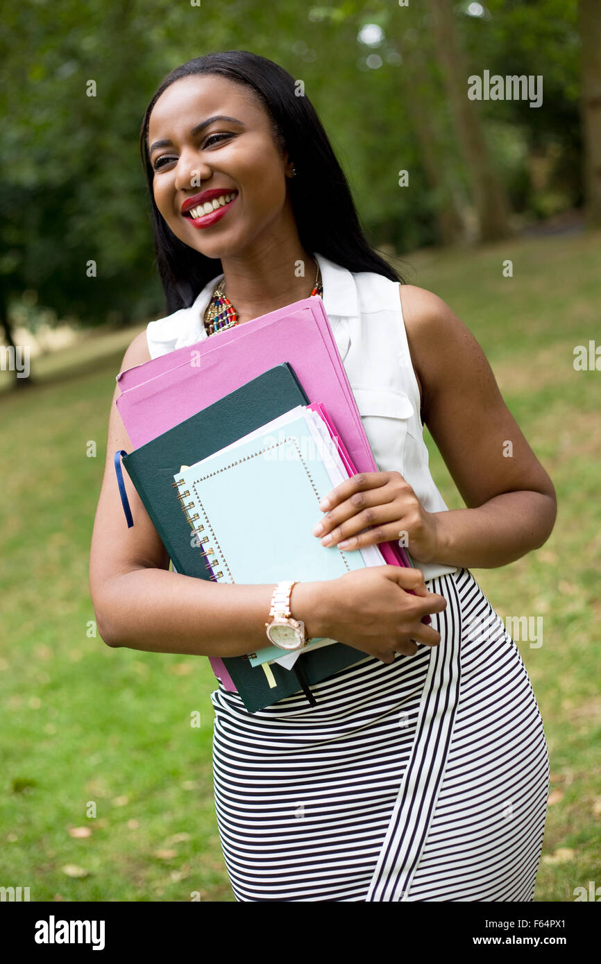 a young student in the park holding her books Stock Photo - Alamy