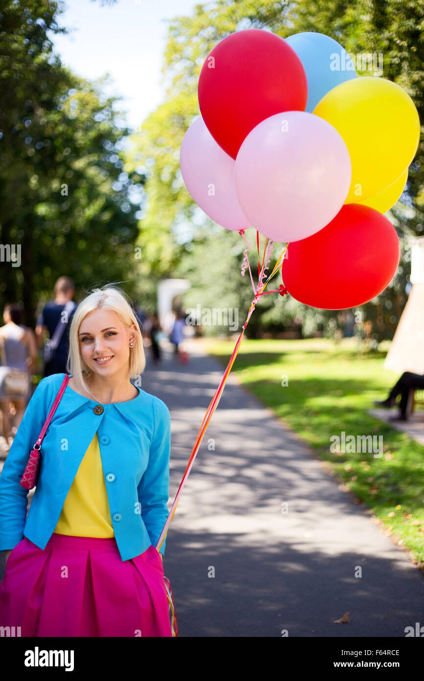 young woman in the park with a bunch of balloons Stock Photo - Alamy