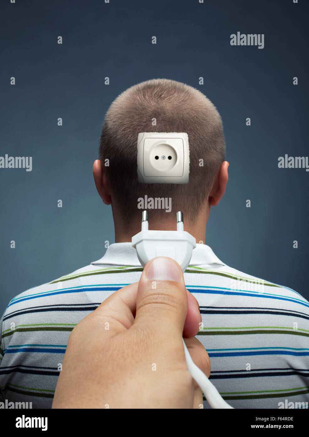 Plugging electrical cable into the outlet in head Stock Photo Alamy