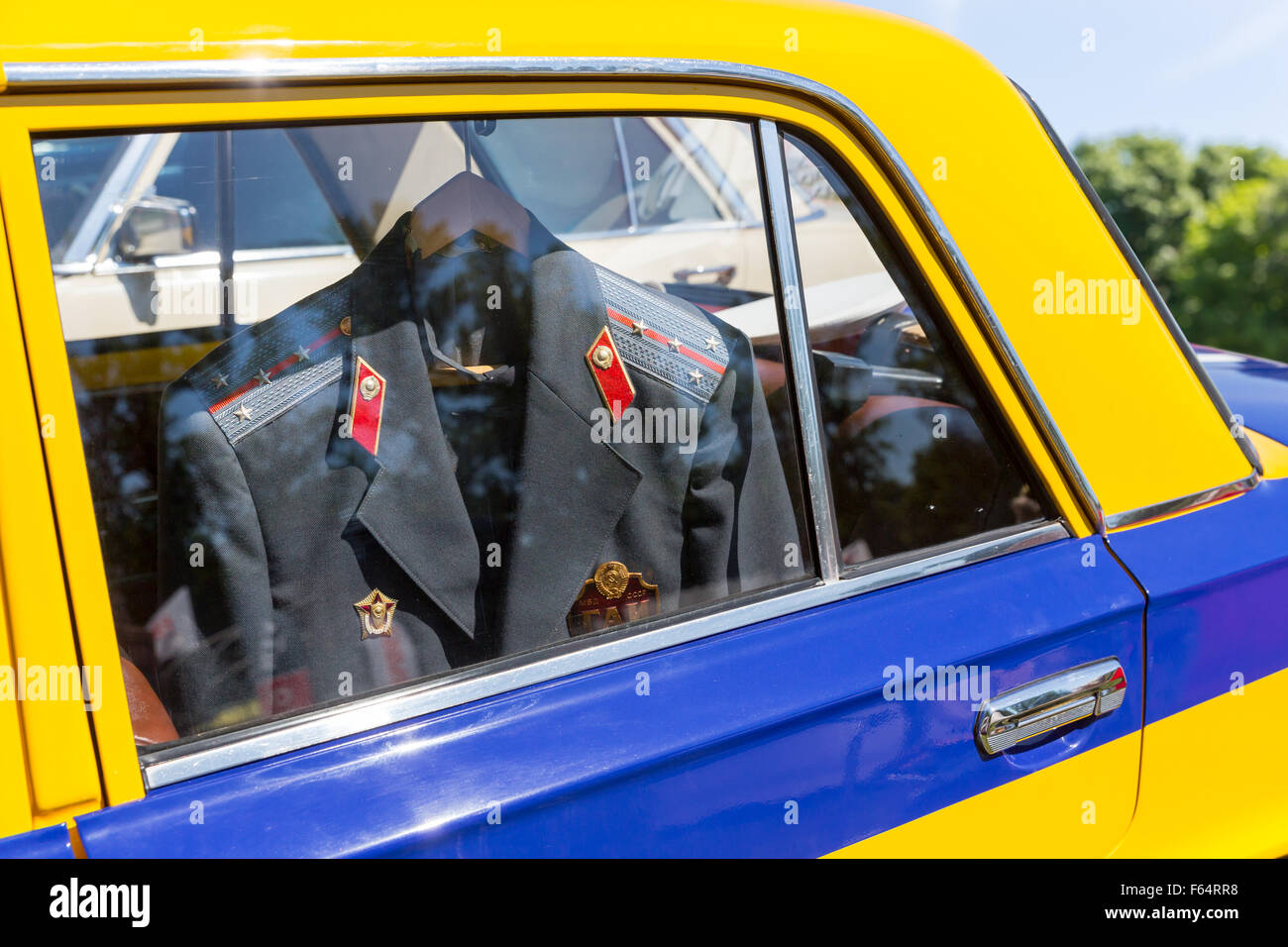 Yellow car with police suit hanging inside Stock Photo
