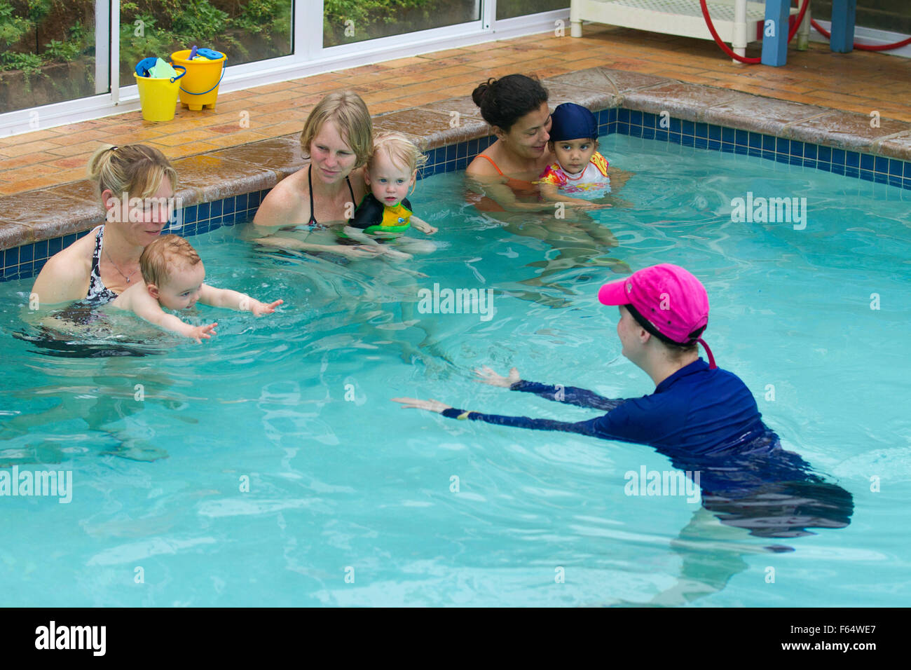Swimming lessons for babies and toddlers indoor heated pool Stock