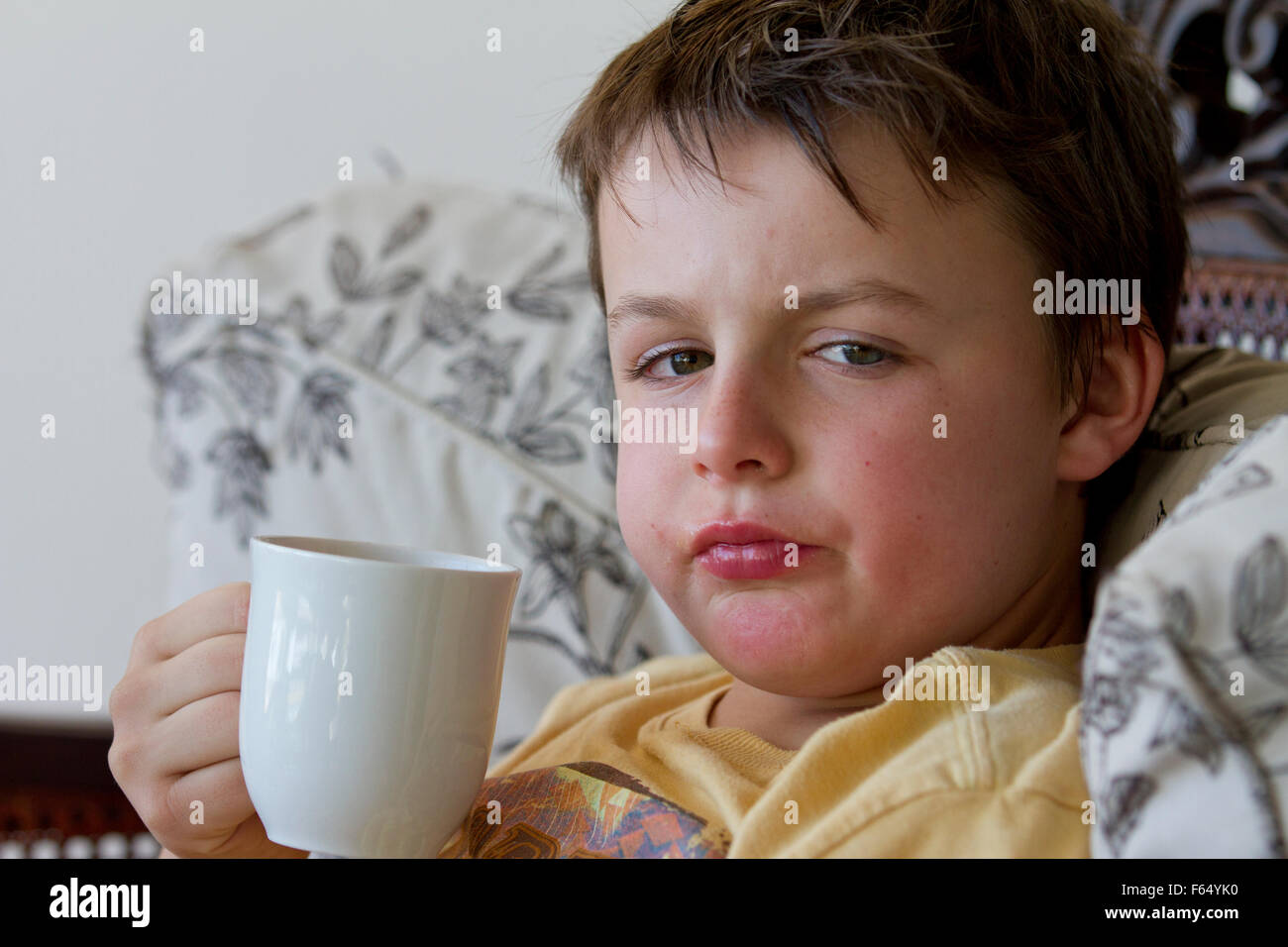 A ten year old boy drinking a hot drink Stock Photo Alamy
