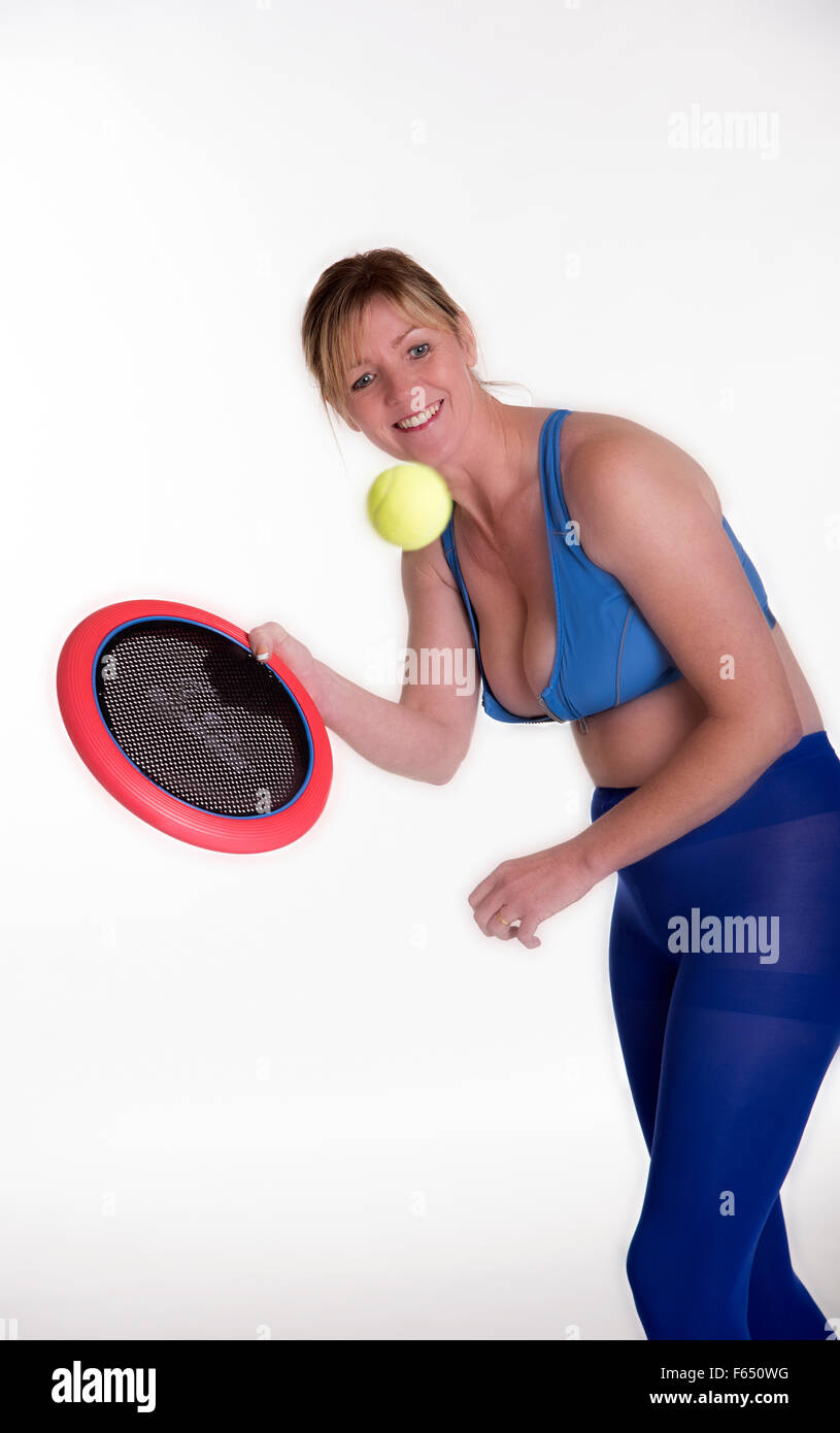 Woman playing a ball game to tone her body and keep fit Stock Photo