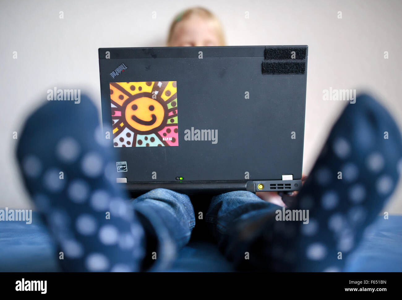 ILLUSTRATION - A child watches a cartoon on a laptop. The photo was taken on 06 January 2015 in Dresden (Saxony). Photo: Thomas Eisenhuth - model released - Stock Photo