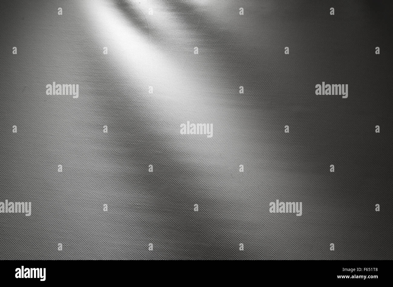 Gray waved fabric background photo texture with spot illumination Stock Photo