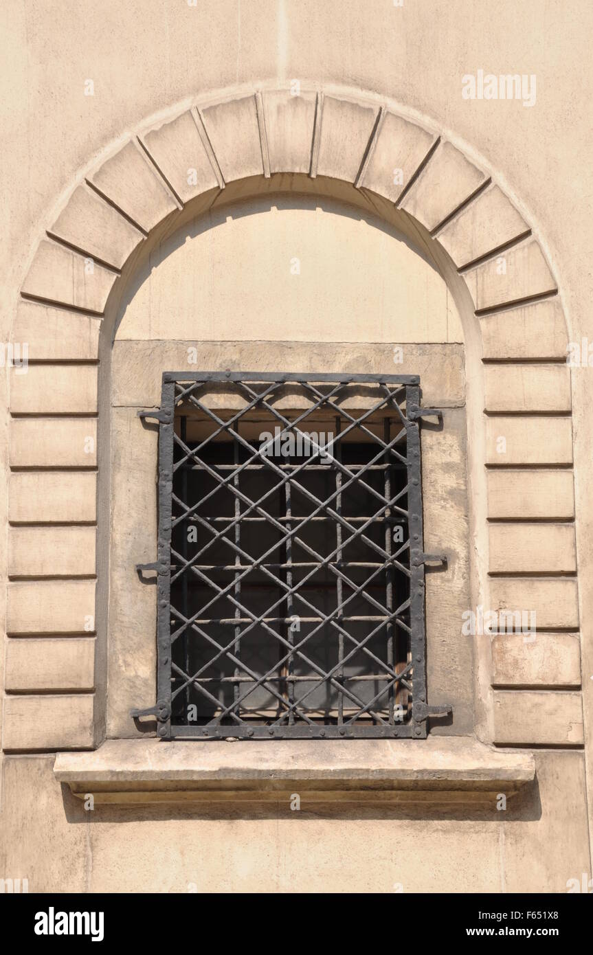 Arched window with iron grid Stock Photo