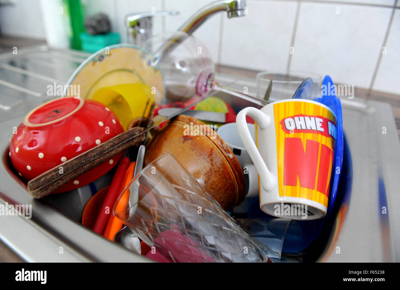 Dirty dishes are piling up in a kitchen sink. The photo was taken on 19 March 2013 in Dresden (Saxony). Photo: Thomas Eisenhuth Stock Photo
