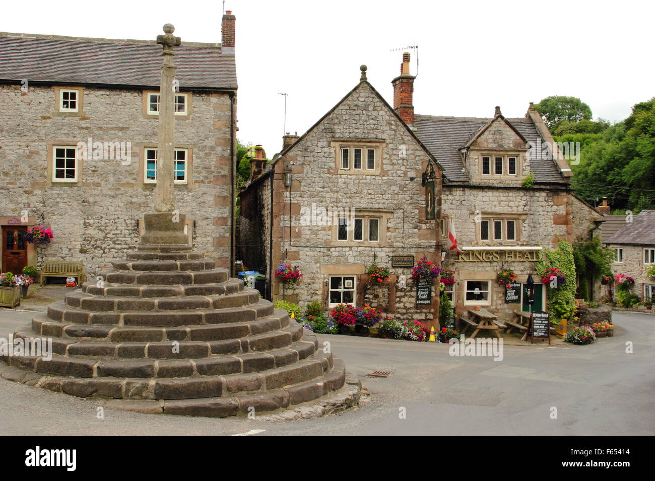 The market cross outside the King's Head public house in the centre of Bonsall village in the Derbyshire Dales England UK,summer Stock Photo