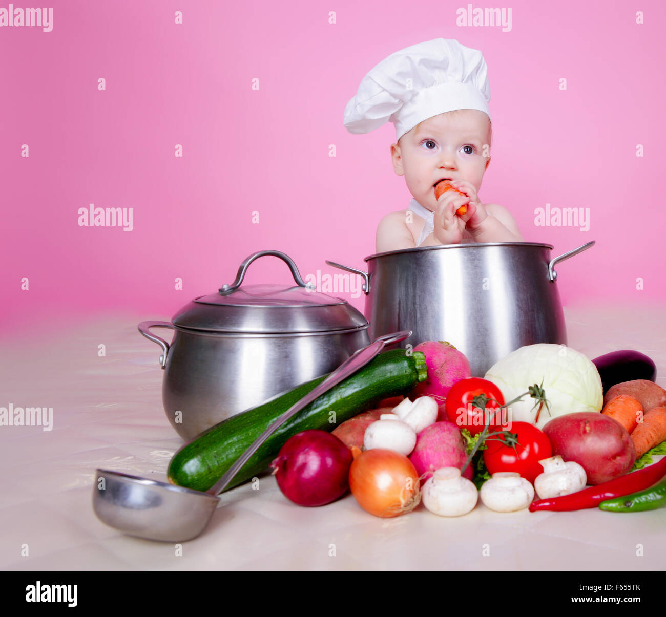 Baby cook in saucepan Stock Photo
