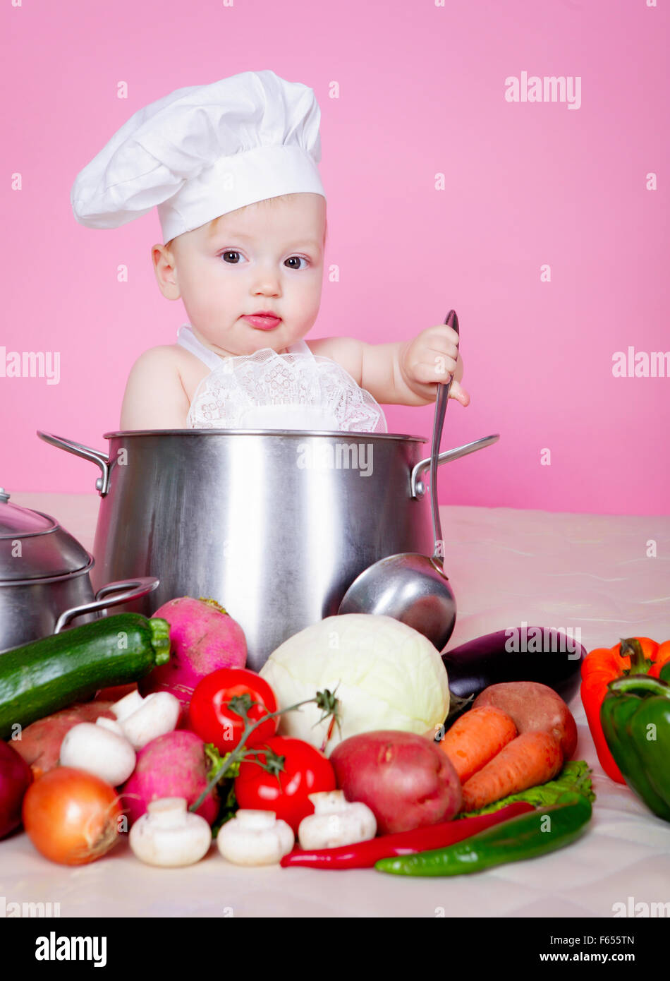 Baby cook in saucepan Stock Photo