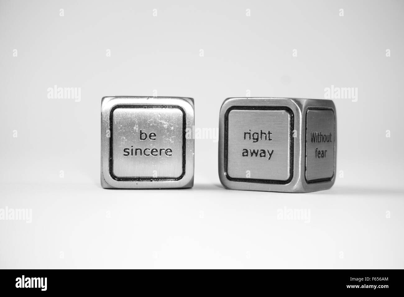 Two dices with messages on them Stock Photo