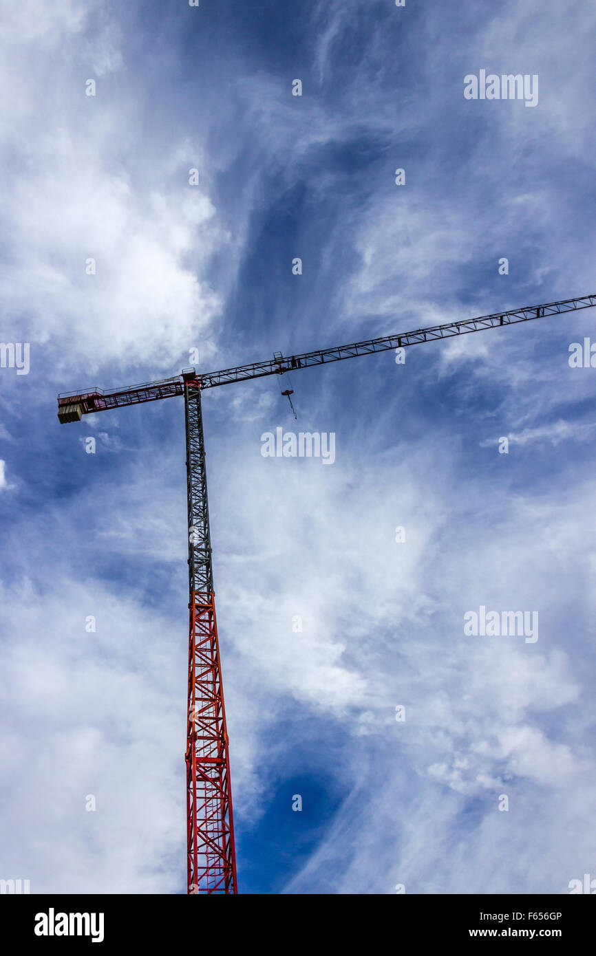 Construction crane on a blue cloudy sky Stock Photo - Alamy