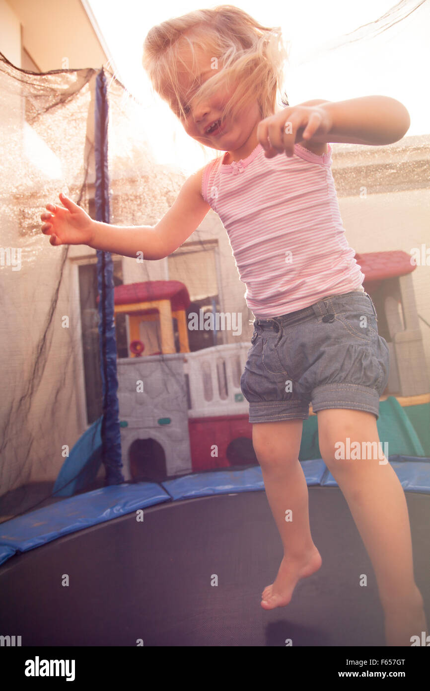 Toddler jumping on a trampoline Stock Photo Alamy