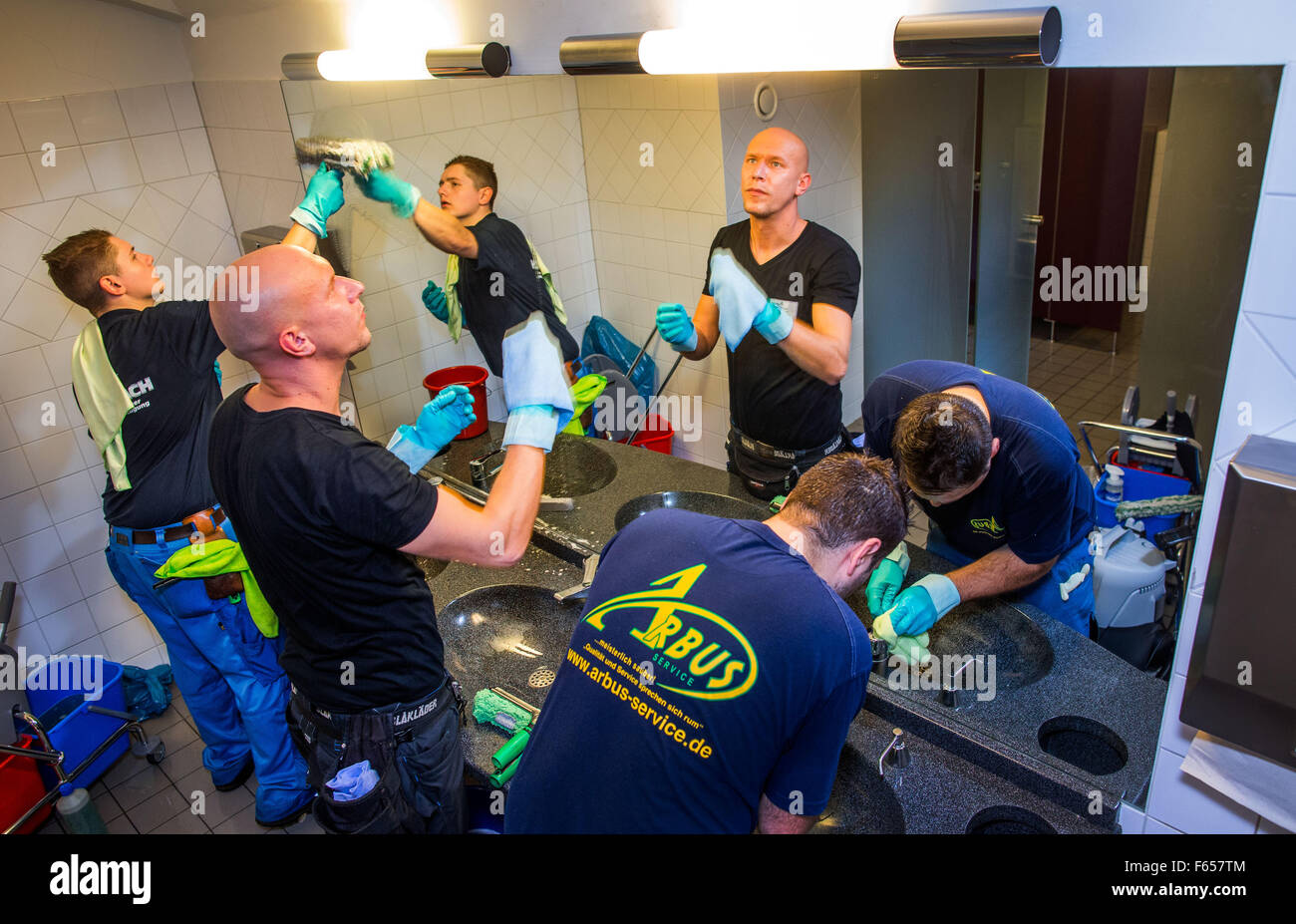 Schwerin, Germany. 12th Nov, 2015. Building cleaners Angelo Scholz (C), Alexandru Florin Lungu (R), and Nico Wiegmann clean the public toilets during the national competition of building cleaner apprentices at the Mecklenburg State Theater in Schwerin, Germany, 12 November 2015. The young contestants took turns cleaning the floors of the foyer, restrooms, and outside windows of the theater. The aim of the annual competition is to support apprentices in their career development and to motivate high performance. Photo: JENS BUETTNER/dpa/Alamy Live News Stock Photo