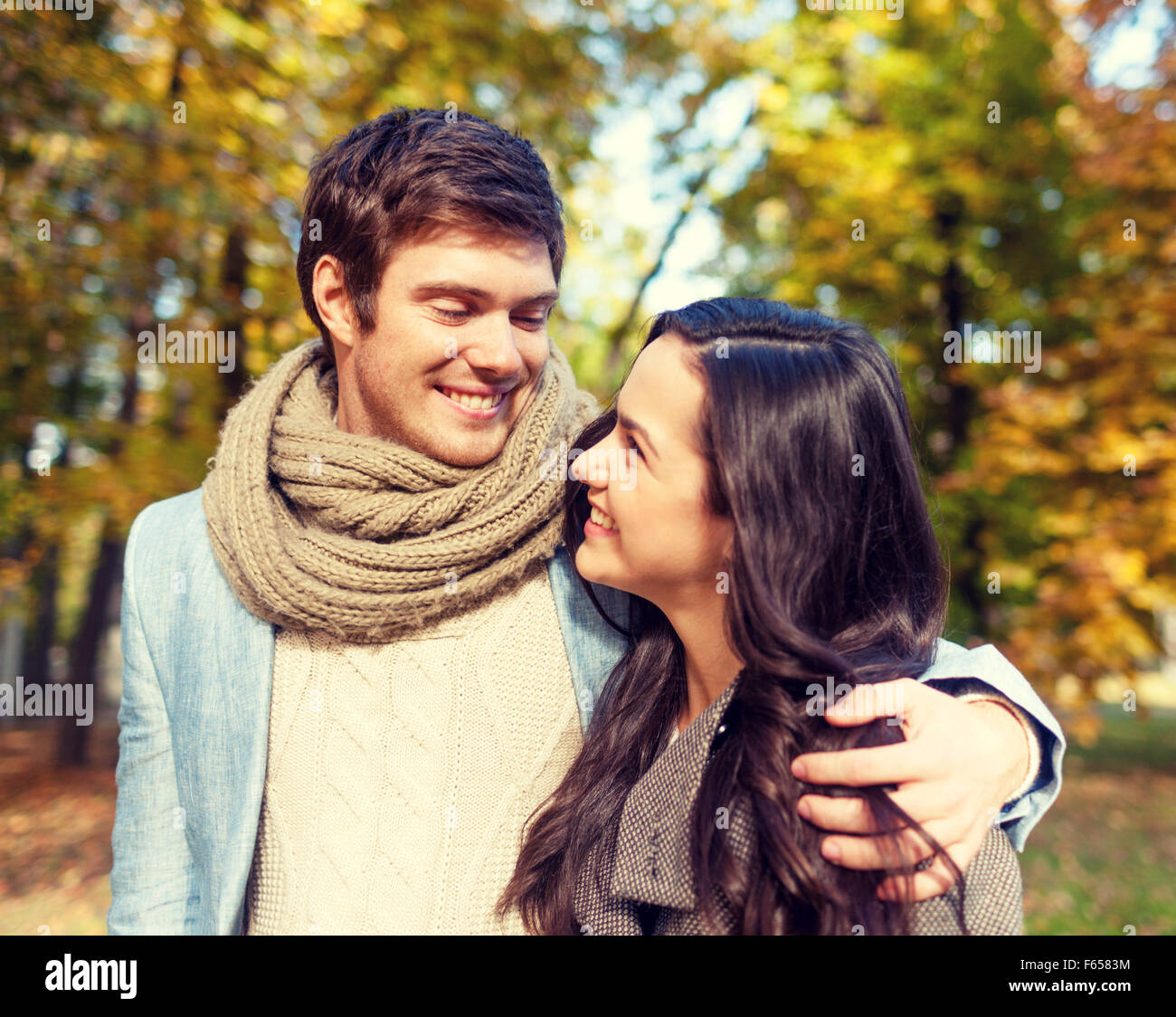 smiling couple hugging in autumn park Stock Photo - Alamy