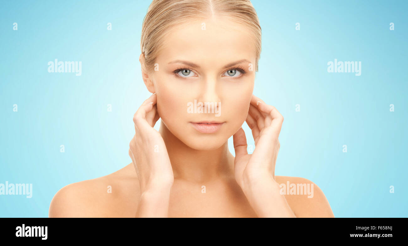 beautiful young woman touching her neck Stock Photo - Alamy