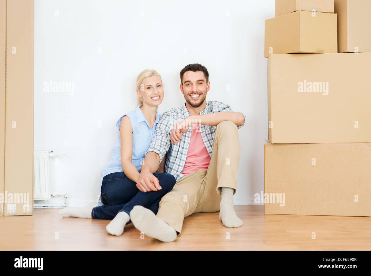 couple with cardboard boxes moving to new home Stock Photo - Alamy