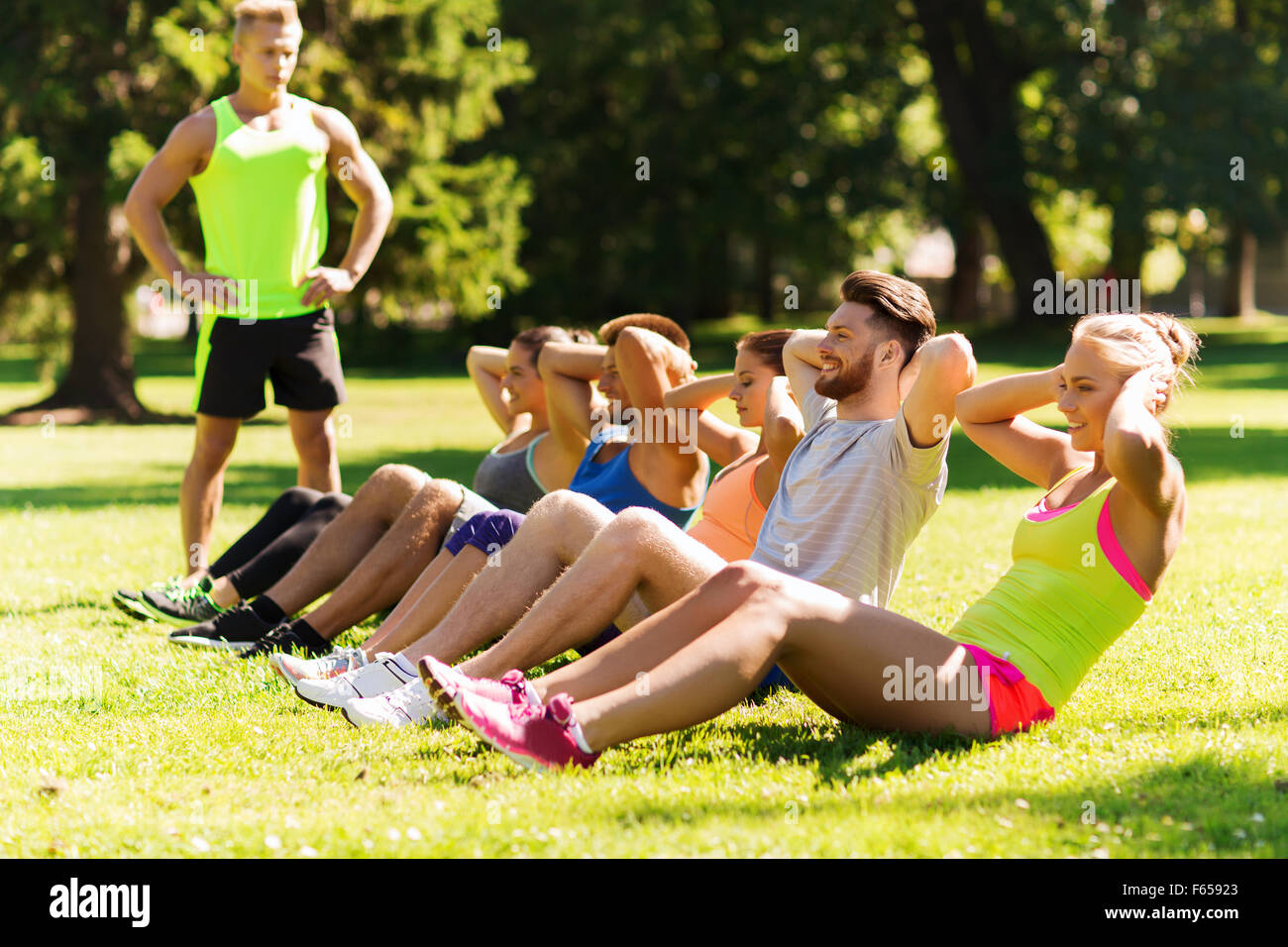 group of friends or sportsmen exercising outdoors Stock Photo