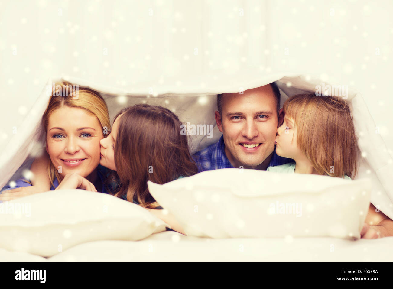 happy family with two kids under blanket at home Stock Photo