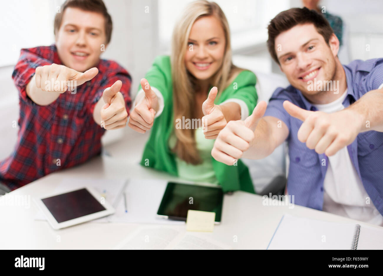 group of happy students showing thumbs up Stock Photo - Alamy