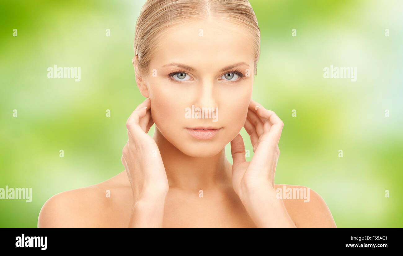 beautiful young woman touching her neck Stock Photo - Alamy