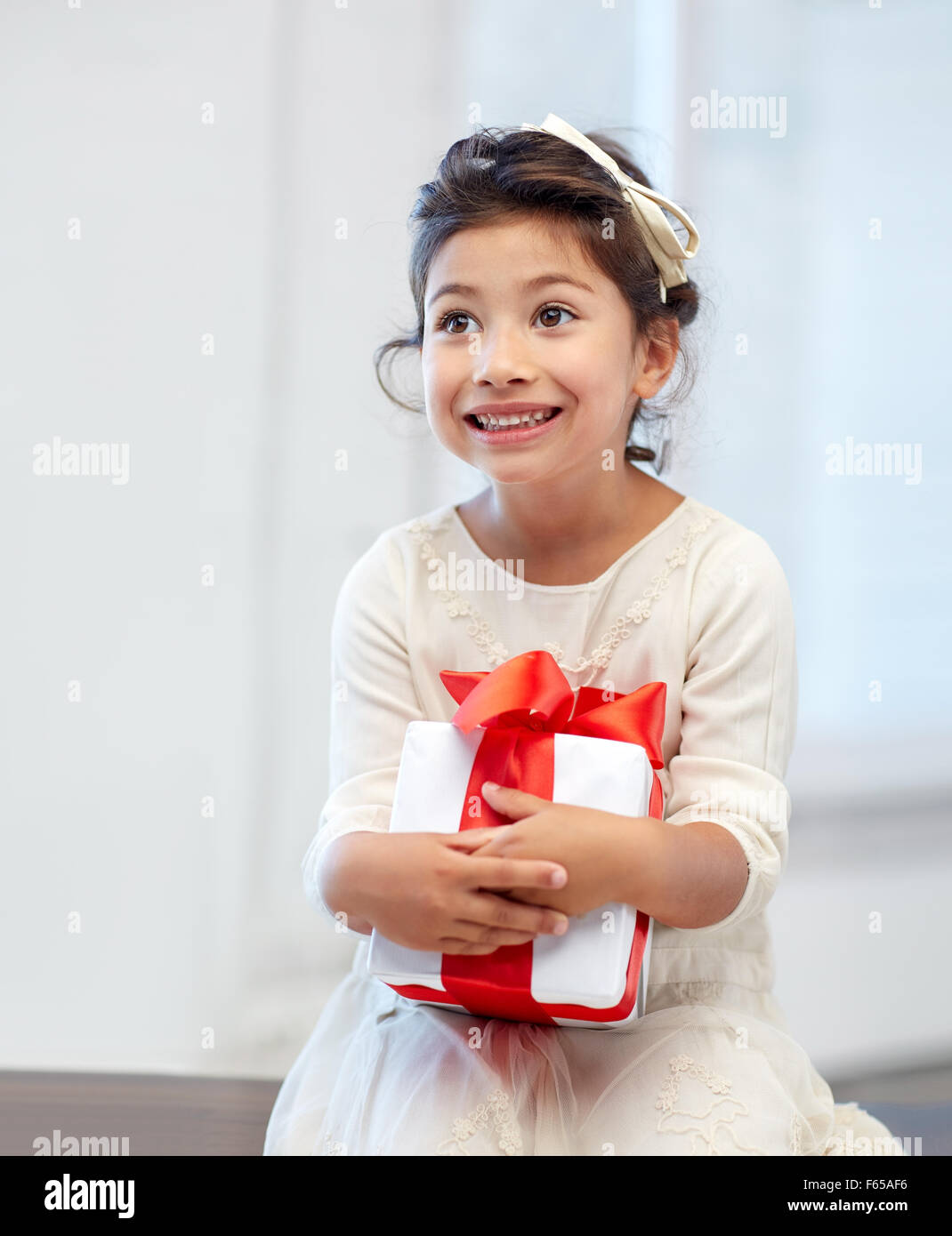 happy little girl with gift box at home Stock Photo Alamy