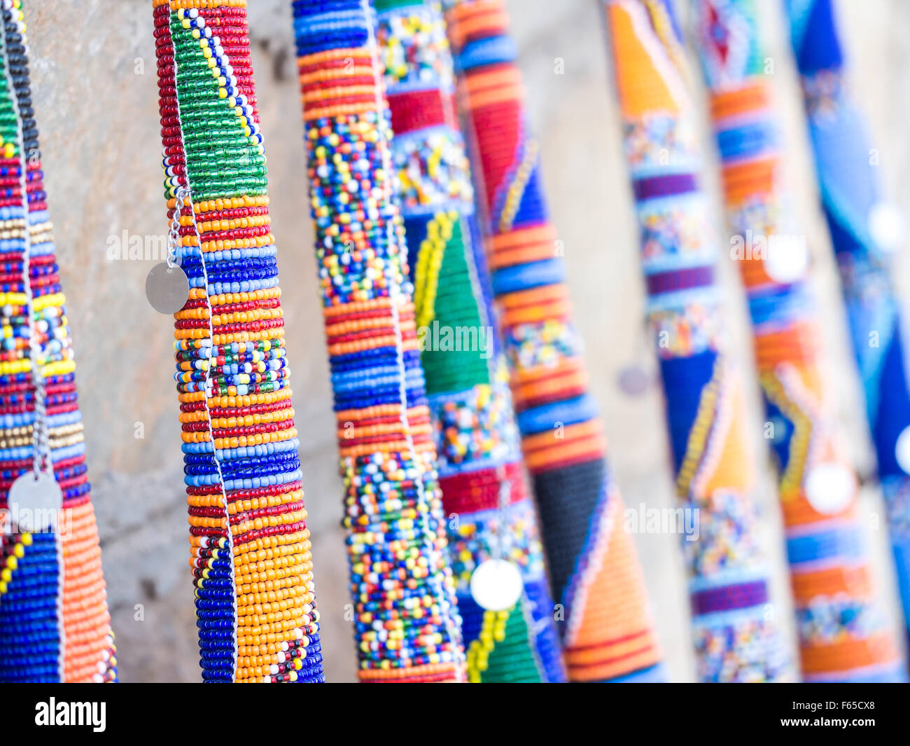 Maasai rungu (club) decorated with beads and sold as a souvenir at a local Maasai Market. Close up. Stock Photo