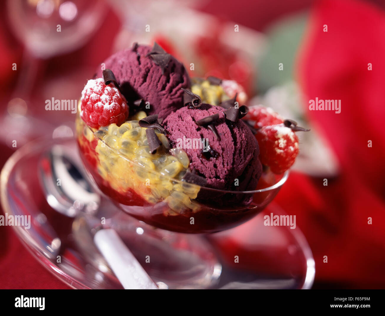 Dish of blackcurrant ice cream with passion fruit Stock Photo