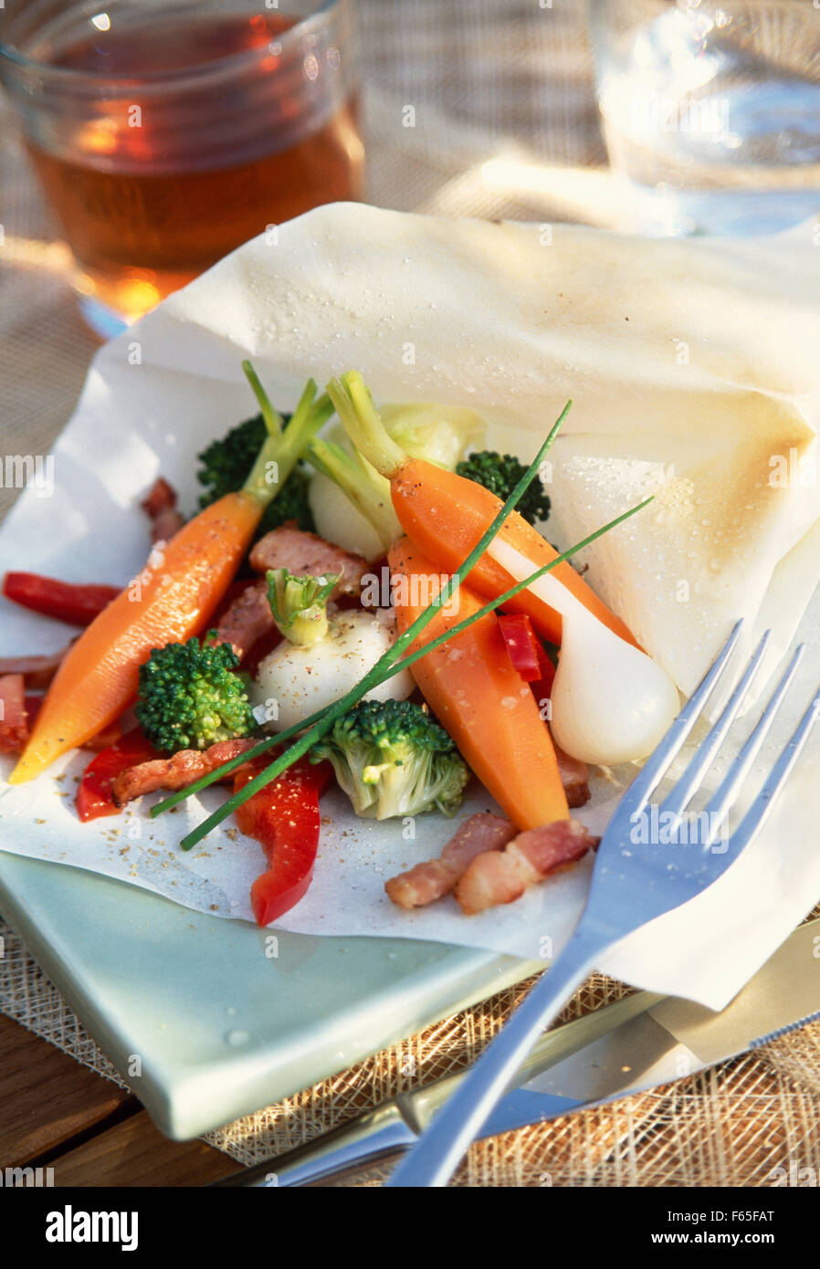 spring baby vegetables with herbs en papillote (topic: papillotes) Stock Photo