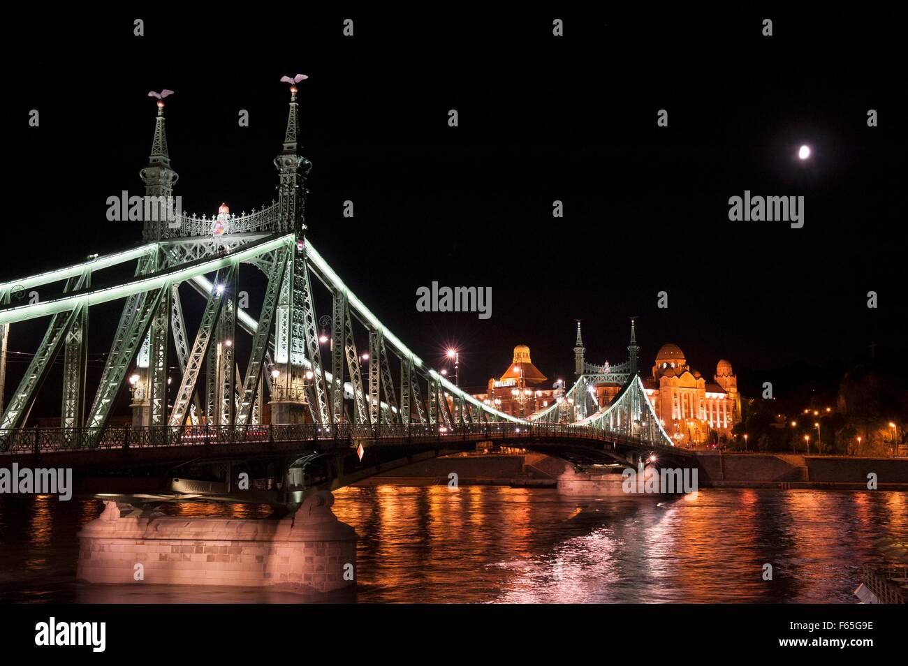 Budapest illuminated in the evening - Liberty Bridge over the Danube leading to the Gellert Hotel, Hungary Stock Photo