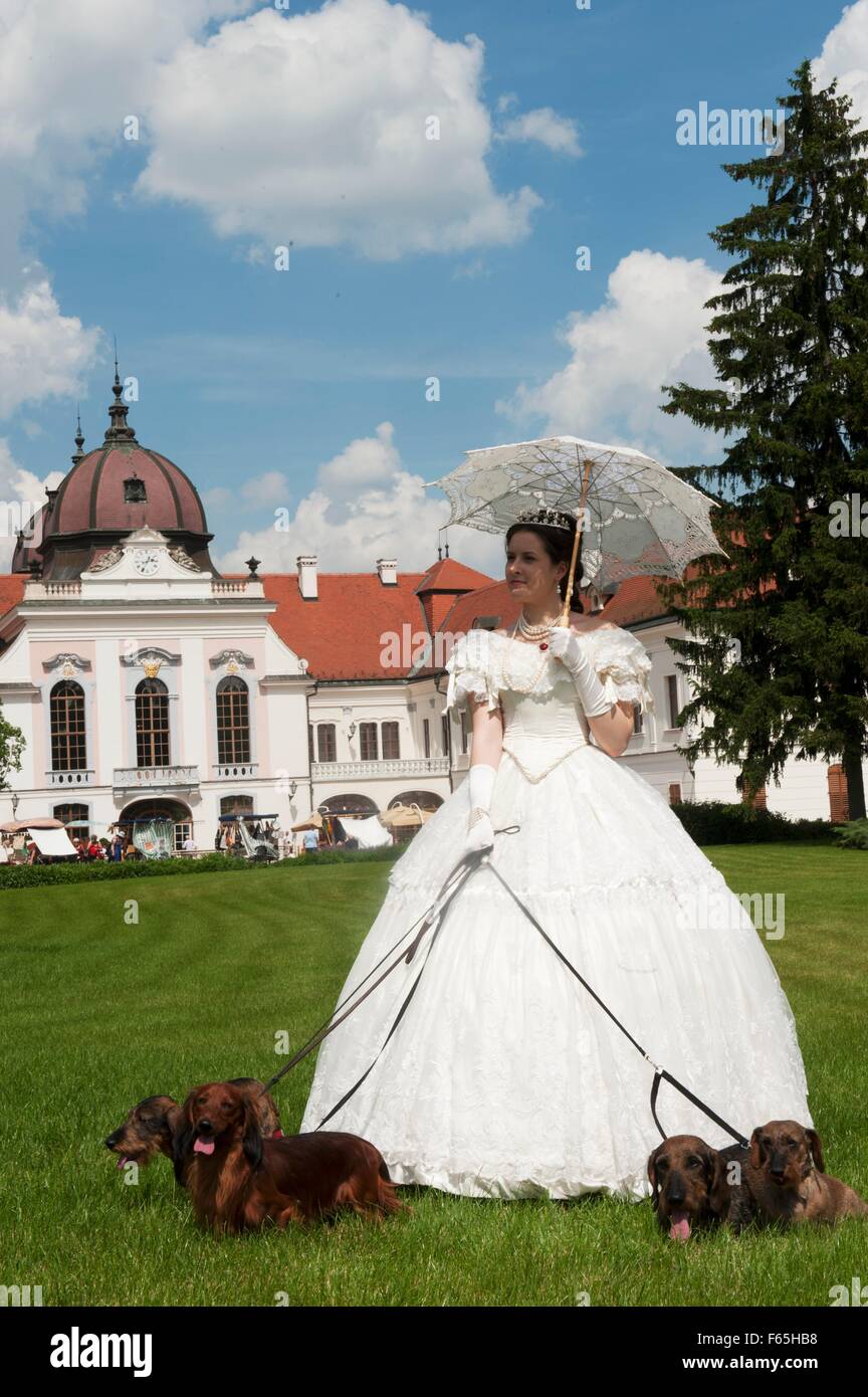 Coronation weekend at the Royal Palace of Gödöllö, , Hungary – fashion show with a crinoline and dogs Stock Photo