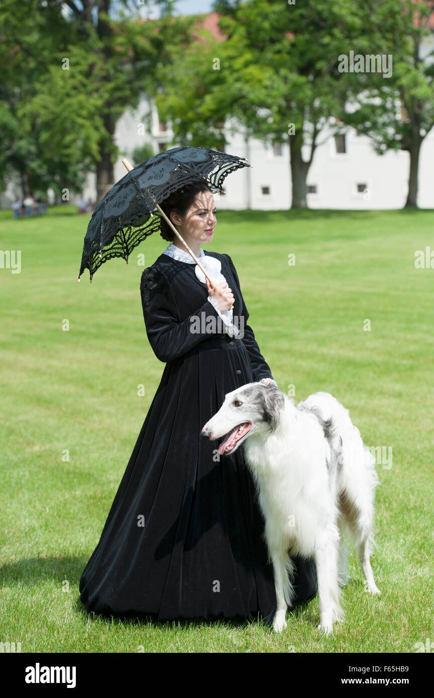 'Coronation Weekend' at Gödöllö Palace, Hungary – fashion show with a high-neck, black-and-white afternoon dress and a dog Stock Photo