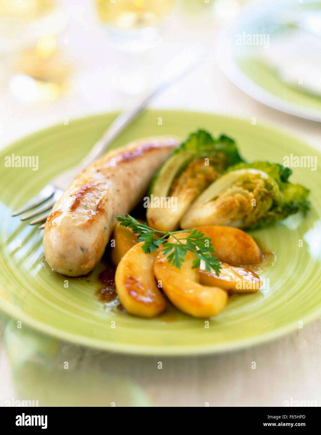 White sausage with apples and mini cabbages Stock Photo