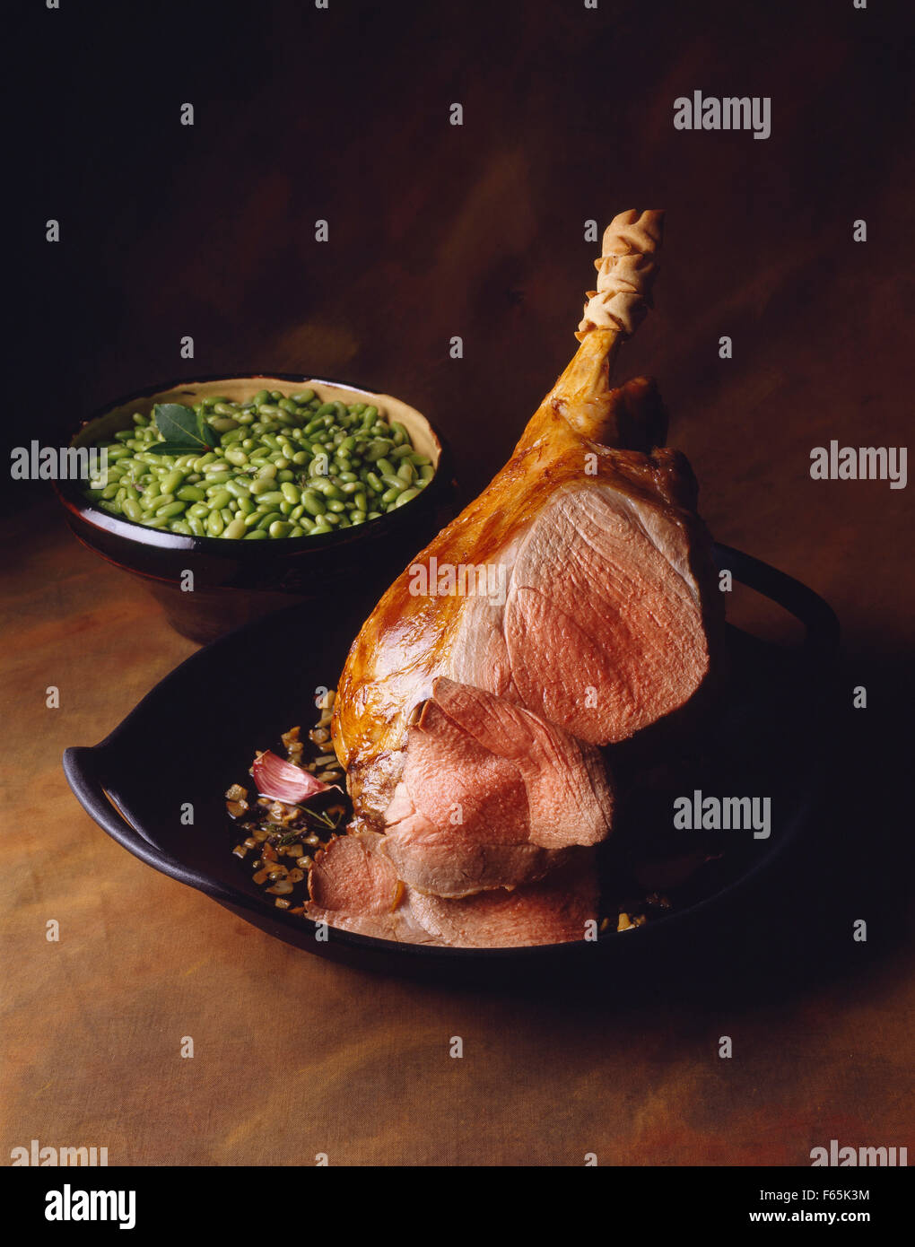 Roast leg of lamb and flageolet beans Stock Photo Alamy
