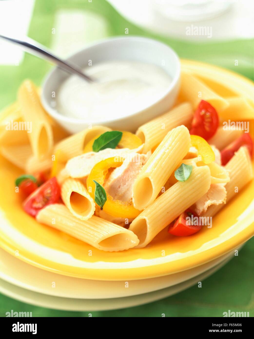 Penne pasta with chicken and white sauce Stock Photo