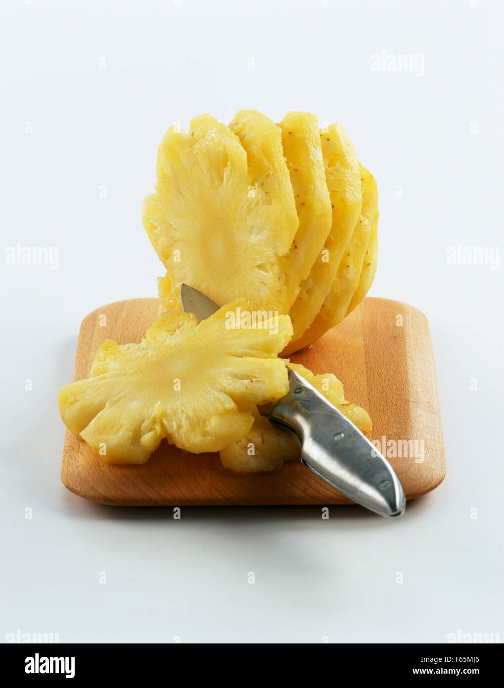 Slicing a pineapple Stock Photo