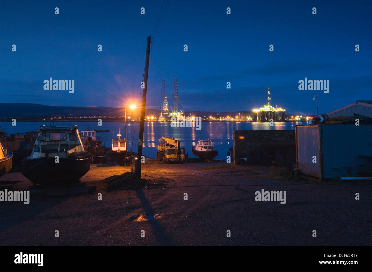 Invergordon with oil rigs at night from Balblair, Ross-shire, Scotland. Stock Photo