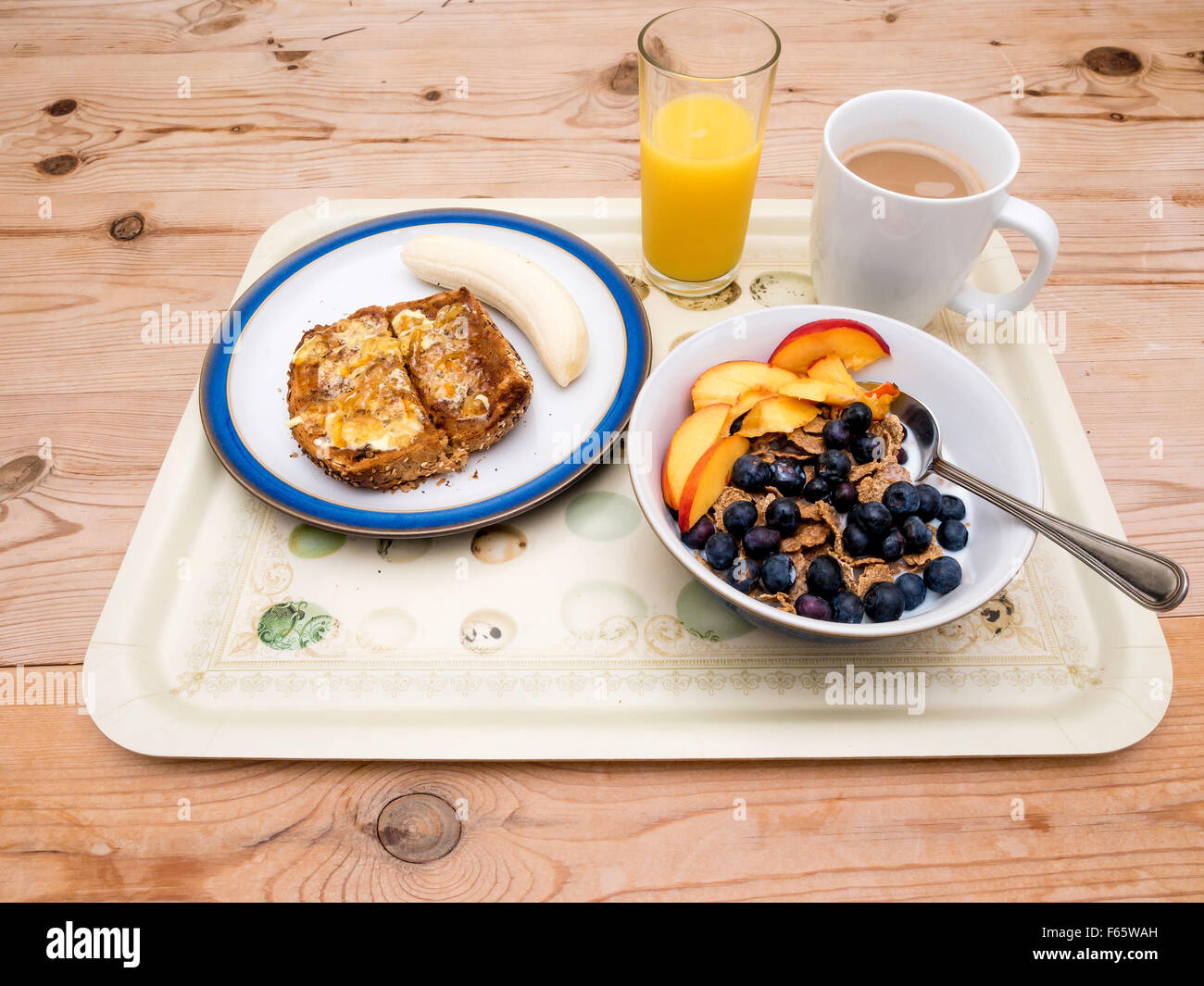 A breakfast tray cereal bran flakes with blueberries and nectarine