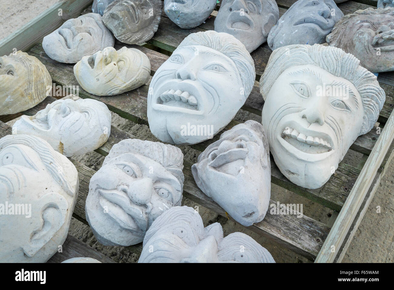Garden ornament grotesque cast stone heads for sale in a garden centre Stock Photo